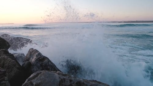Waves Crashing The Rocks Formation On A Seashore
