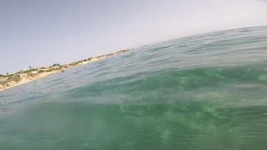 a person swimming over and under the sea water