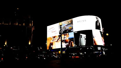 The Giant Screen Of An Electronic Billboard Lighting Up The Street In London At  Night