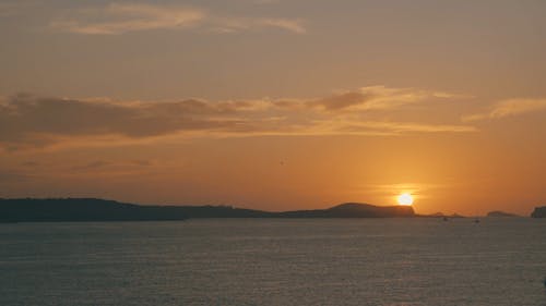 View Of The Sun Setting Behind The Mountains