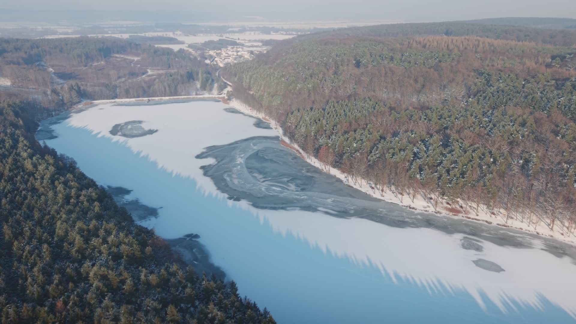 Aerial View of a Frozen Lake and Snowy Forest Free Stock Video Footage ...