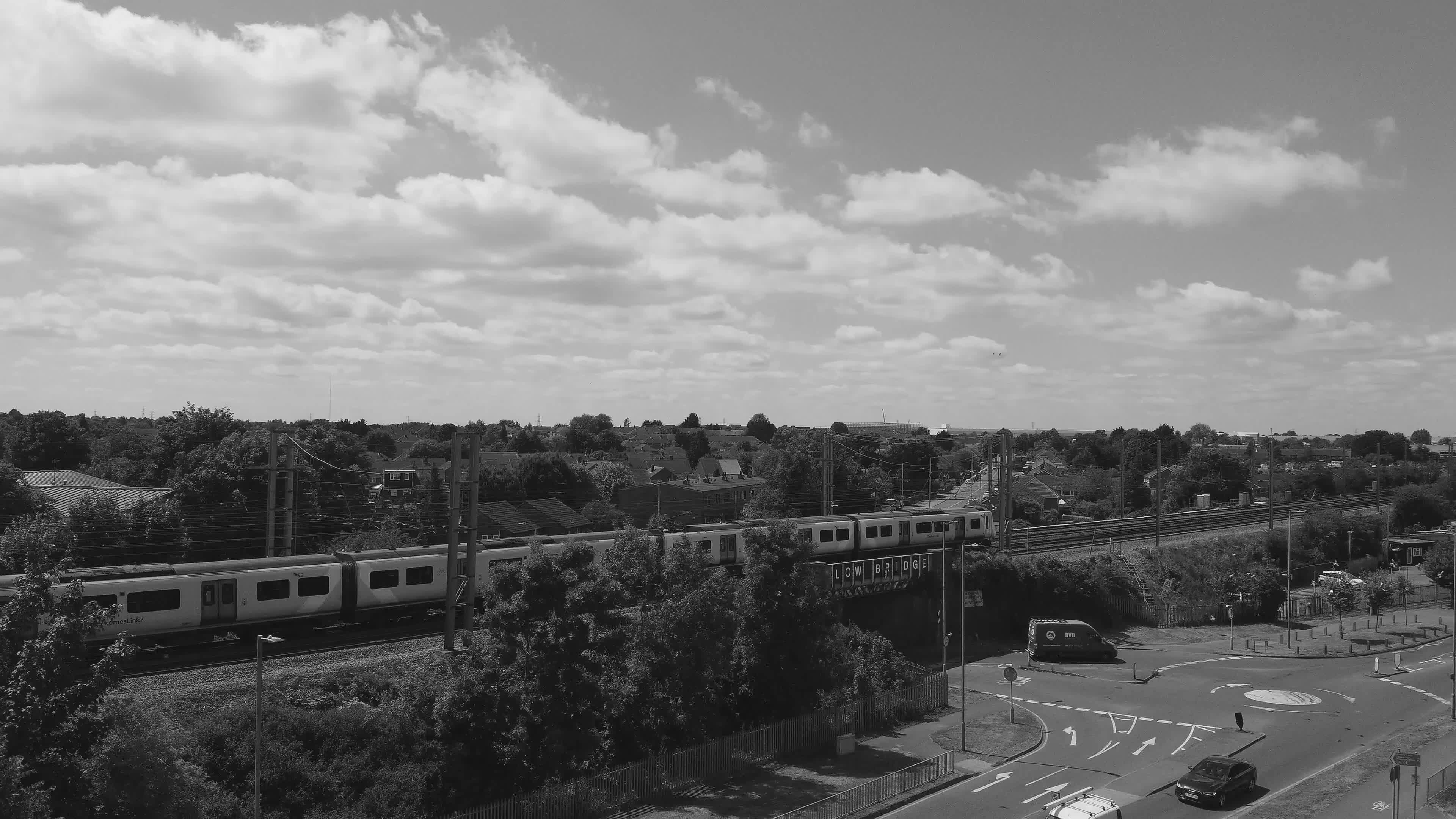 aerial view of train passing through suburban area 36017100