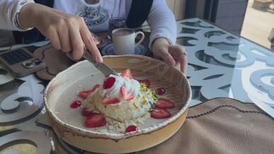 woman enjoys dessert with strawberries