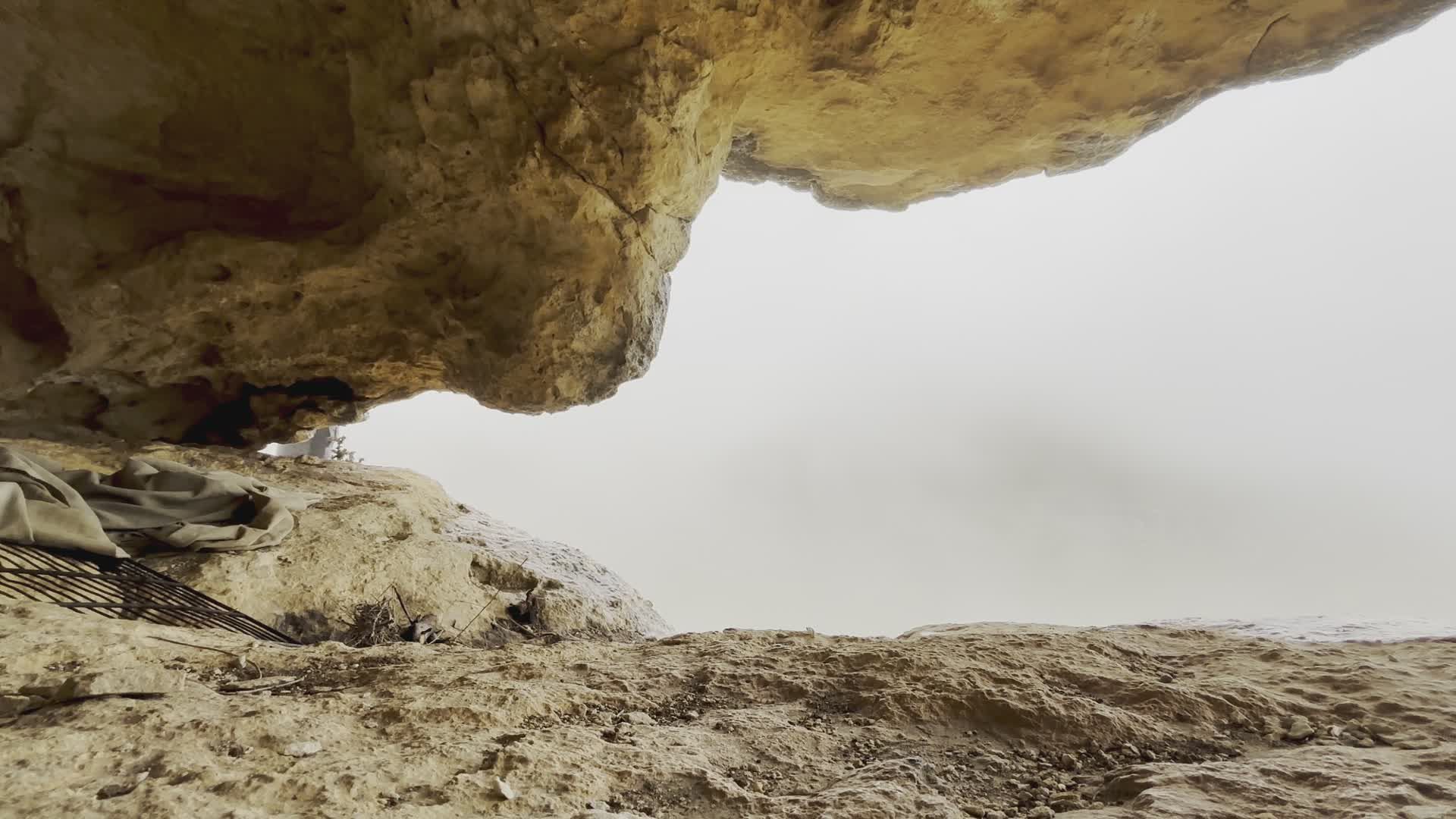 Hiker Explores Misty Cave Under Rocky Overhang Free Stock Video Footage ...