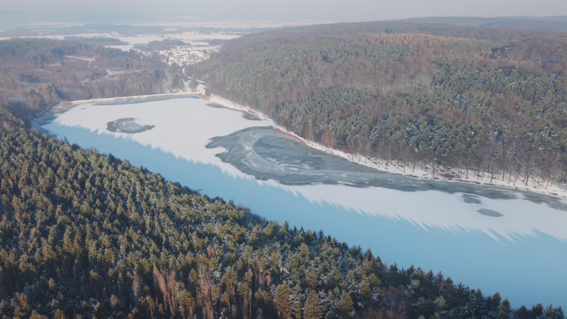 Aerial View of Snowy Forest and Frozen Lake Free Stock Video Footage ...
