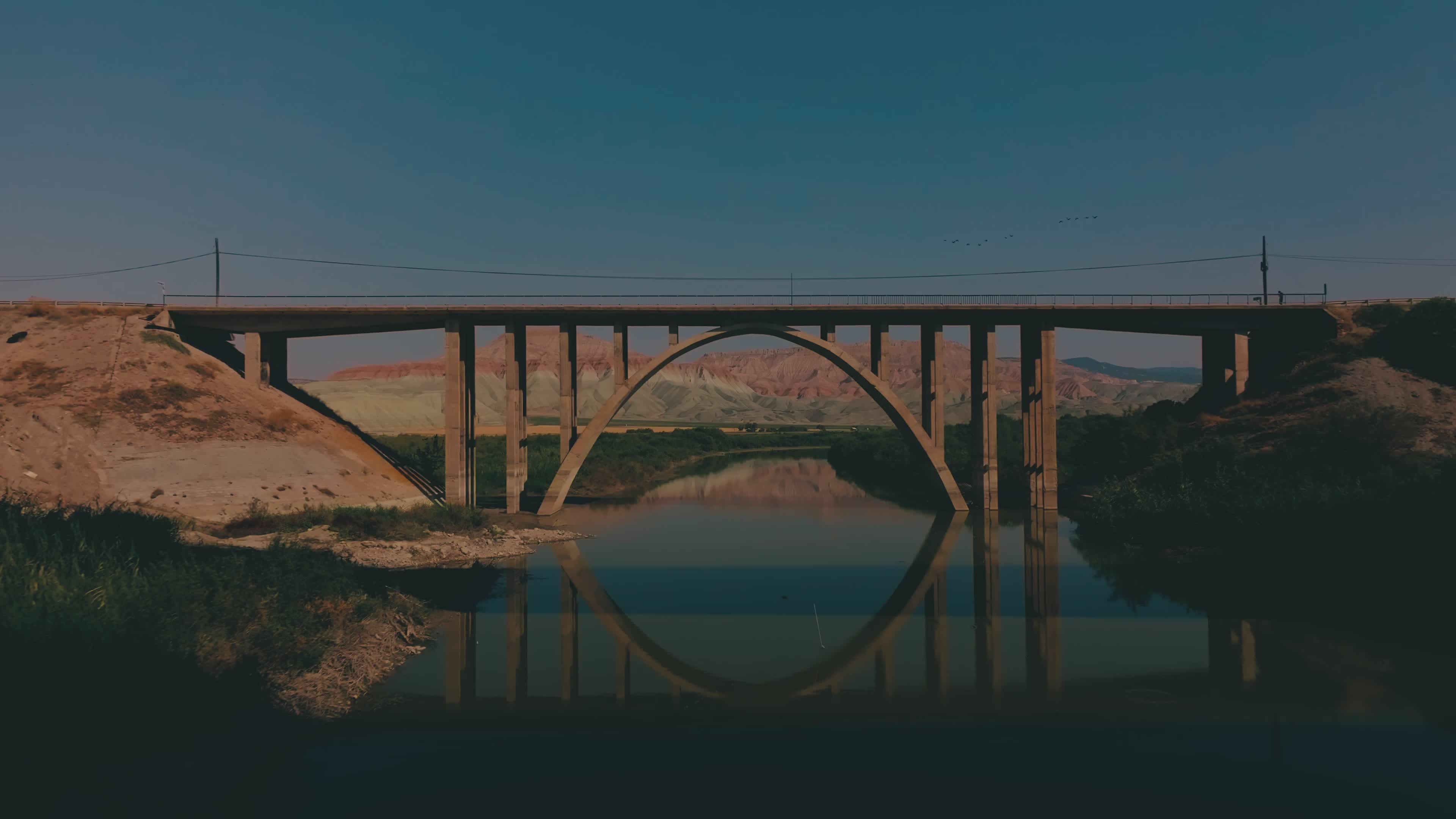 Scenic Bridge over Calm River Reflecting Landscape Free Stock Video ...