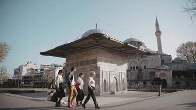 tourists strolling near istanbul s historic mosque