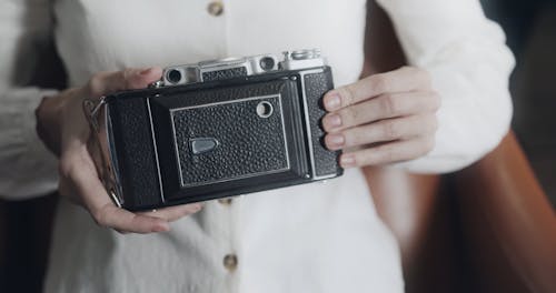 Person Holding A Vintage Camera