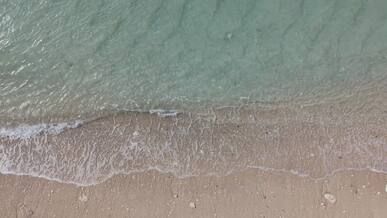 aerial view of serene ocean waves and sandy beach