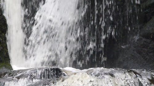 River Flowing From The Basin Of A Water Fall