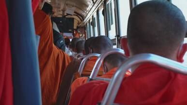 buddhist monks traveling on bus journey