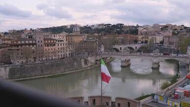 scenic view of rome with italian flag and bridge