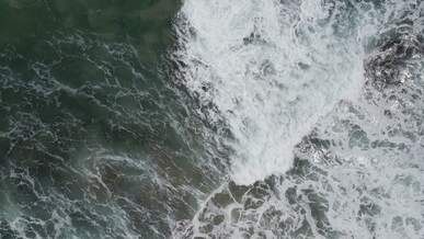 aerial view of crashing beach waves