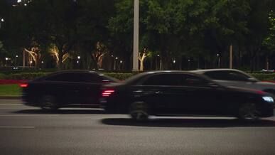 nighttime city street with moving traffic