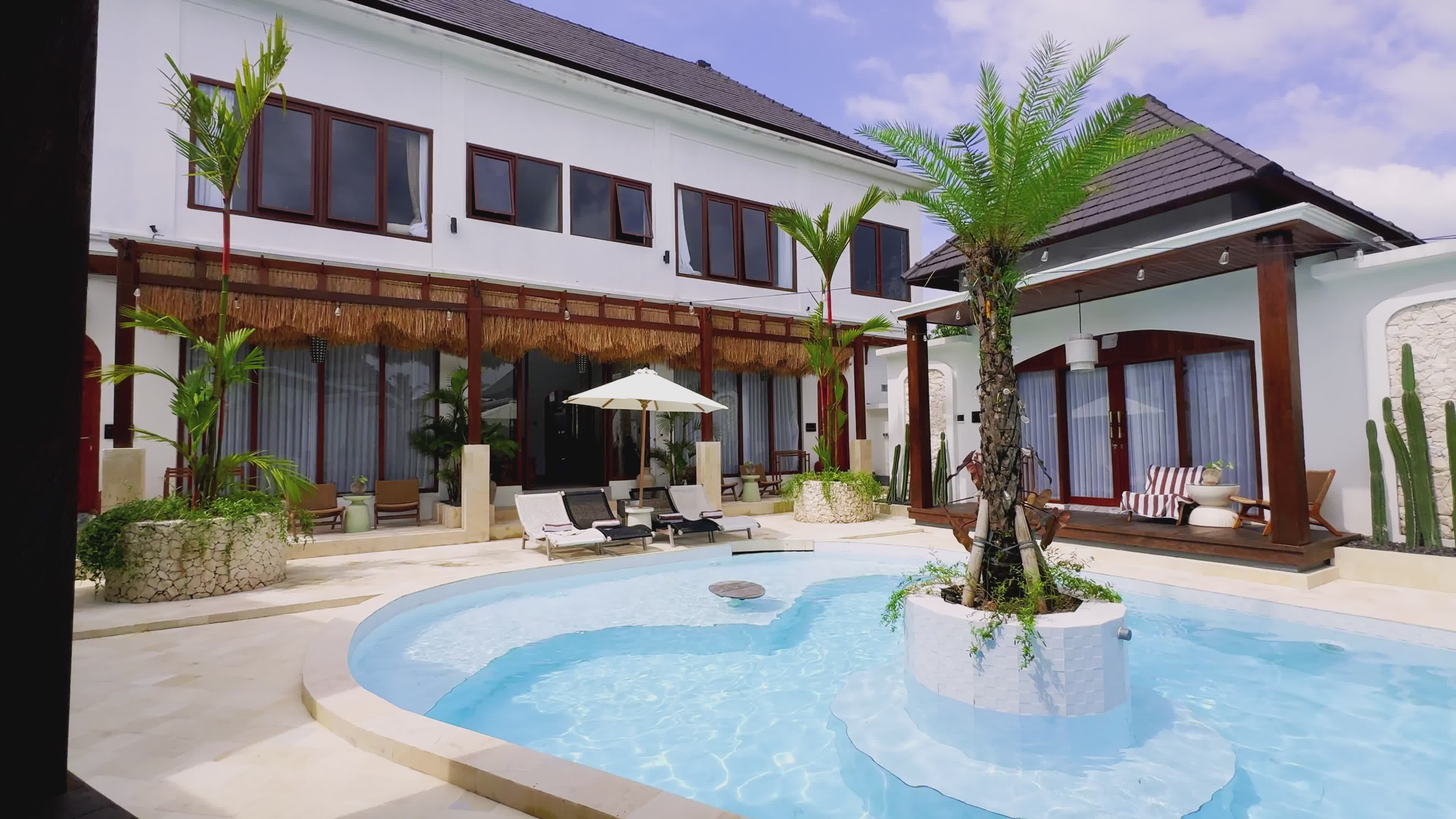 A modern villa and its pool at dusk