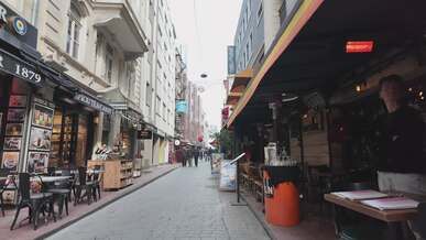vibrant city street with shops and pedestrians