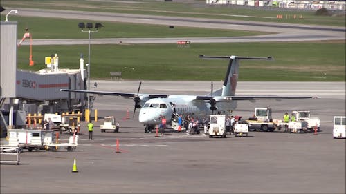 Passenger Disembarking From A Turboprop Passenger Plane In Montreal Airport