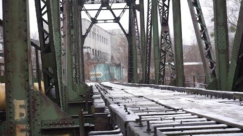 A Bridge Made Of Steel And Wooden Platform