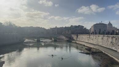rowers on tiber river in rome