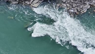 aerial view of rapid river flowing over rocks