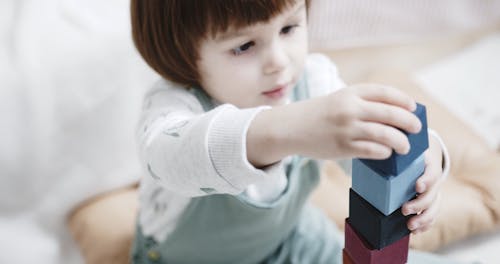 A Little Girl Playing Wooden Blocks