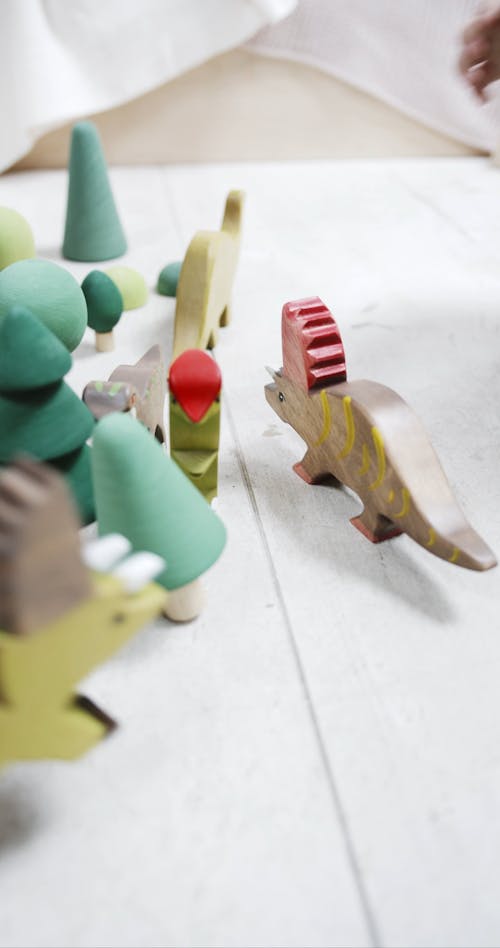 Children Playing Wooden Toys On The Floor