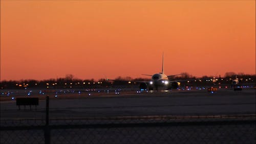 Passenger Planes Taxiing On The Airport Runway