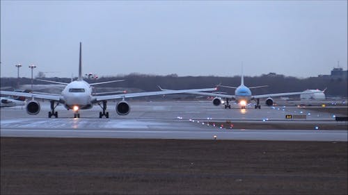 Passenger Airplanes Of Different Airlines Taxiing On The Airport Ground