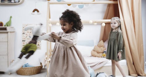 A Girl Joyfully Spinning Around With Her Doll