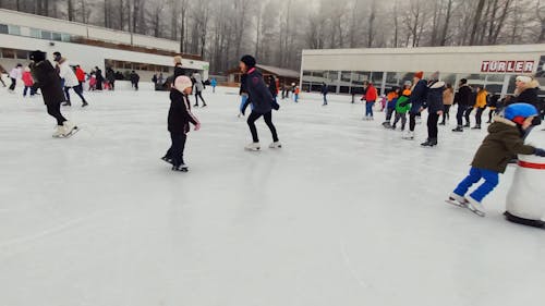 A Crowd Of People Skating In A Skating Rink