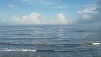 serene ocean waves under blue sky