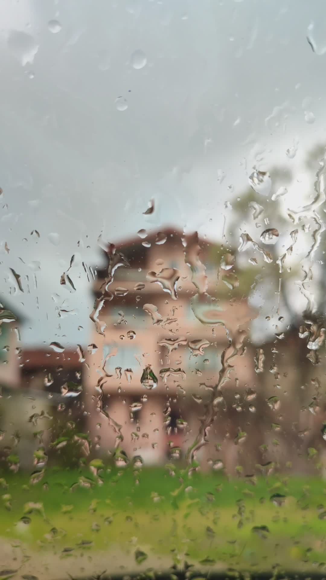 rain drenched view of house through window 37019548