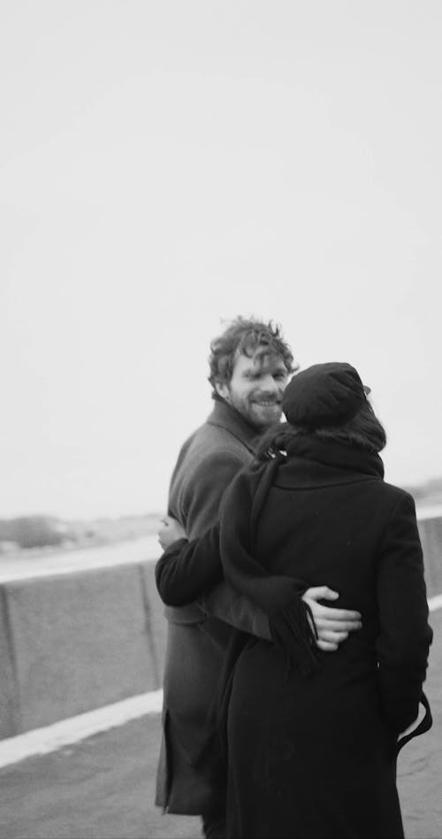 Happy Couple Walking Along A Paved Road