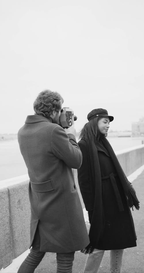 A Woman Playfully Posing For A Video Recording 