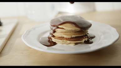 plating pancakes with melted chocolate toppings