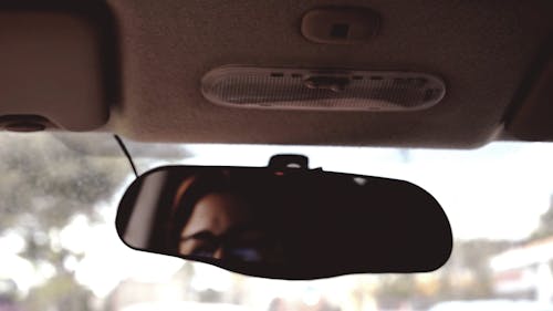 A Woman Driving On A Traffic Road