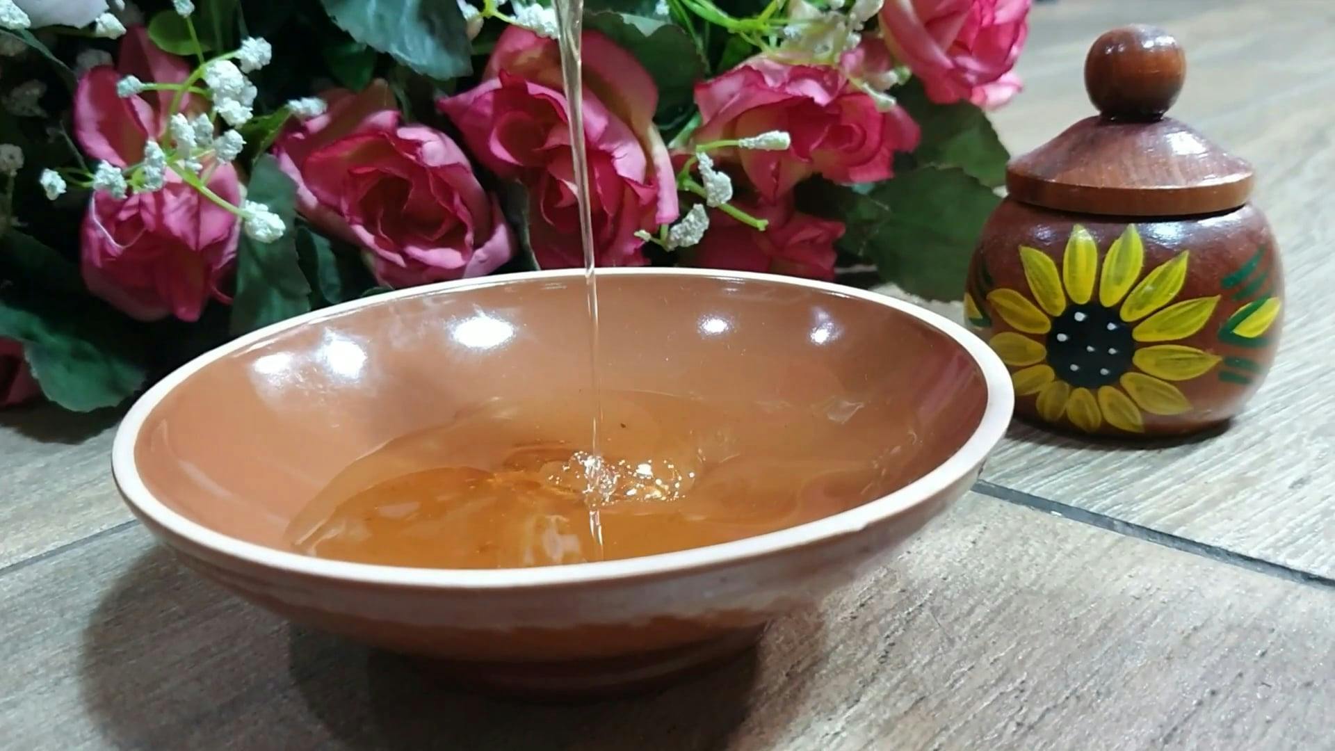 A Person Adding Honey in a Tea using a Honey Dipper Free Stock Video