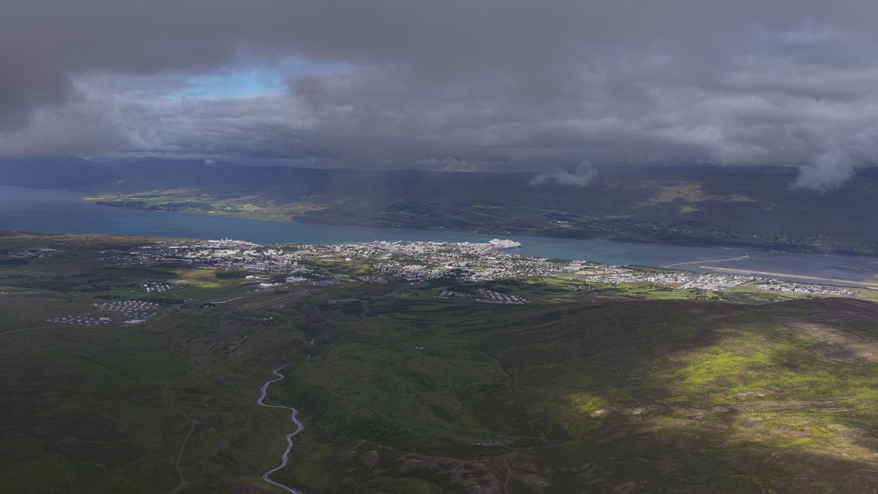 Dramatic Aerial View of Coastal Town Under Cloudy Sky Free Stock Video ...