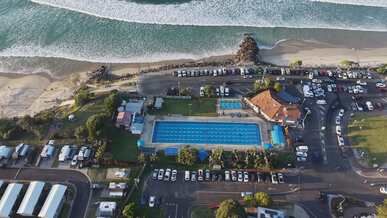 aerial view of oceanfront beach and pool area