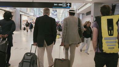 travelers walking through busy airport terminal