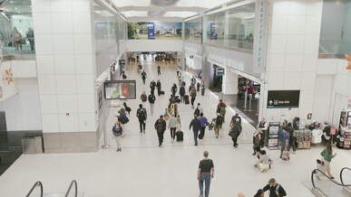 busy airport terminal with people traveling