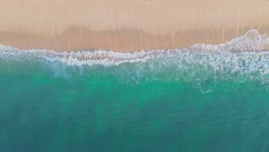aerial view of tranquil beach and waves
