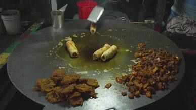 street food vendor cooking delicious rolls