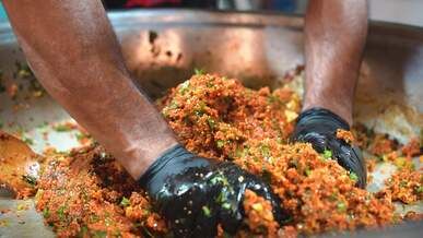 vibrant street food preparation in stainless steel bowl