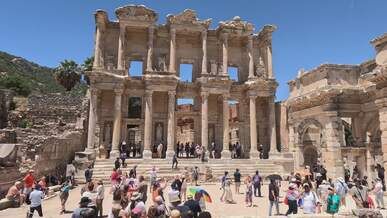 tourists explore ancient ephesus library ruins