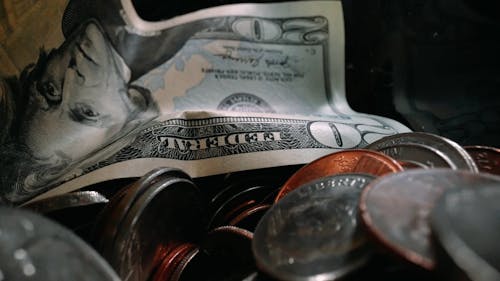 Close-up View Of Paper Money Inside A Bottle