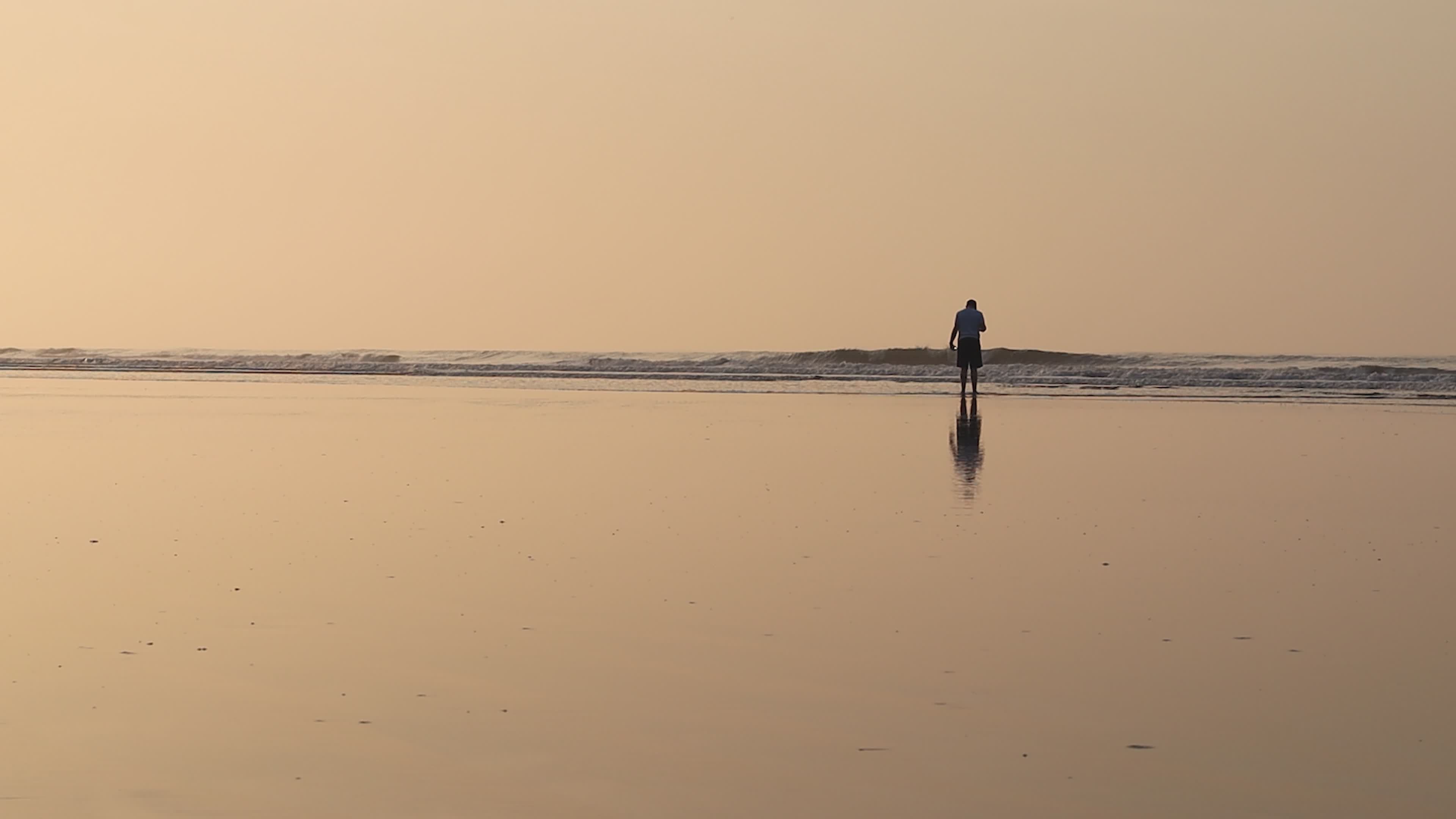 Solitary Figure on Serene Beach at Sunrise Free Stock Video Footage ...