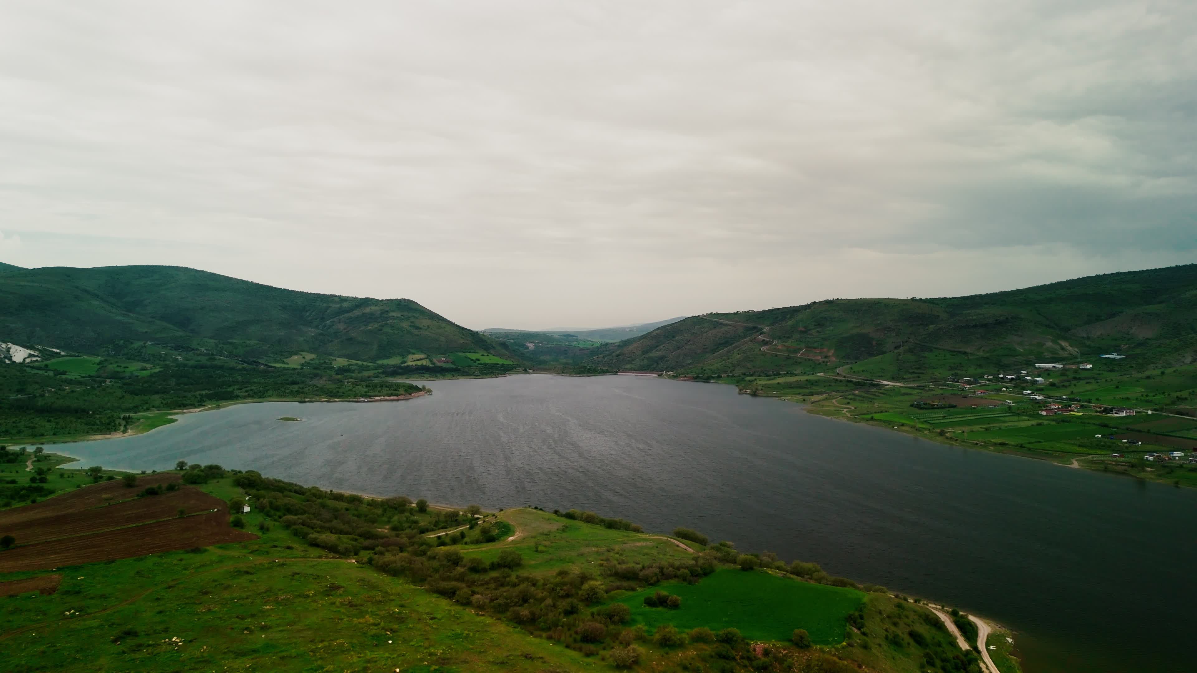 Serene Aerial View of Lake and Green Hills Free Stock Video Footage ...