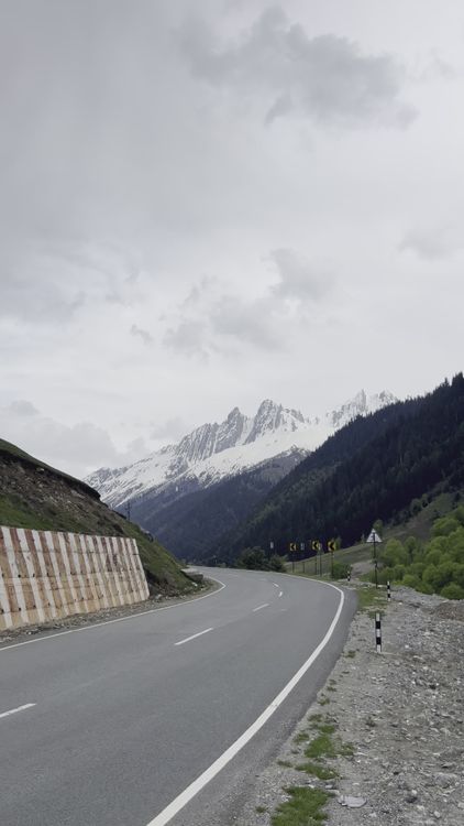 Scenic Mountain Road with Snow-Capped Peaks Free Stock Video Footage ...