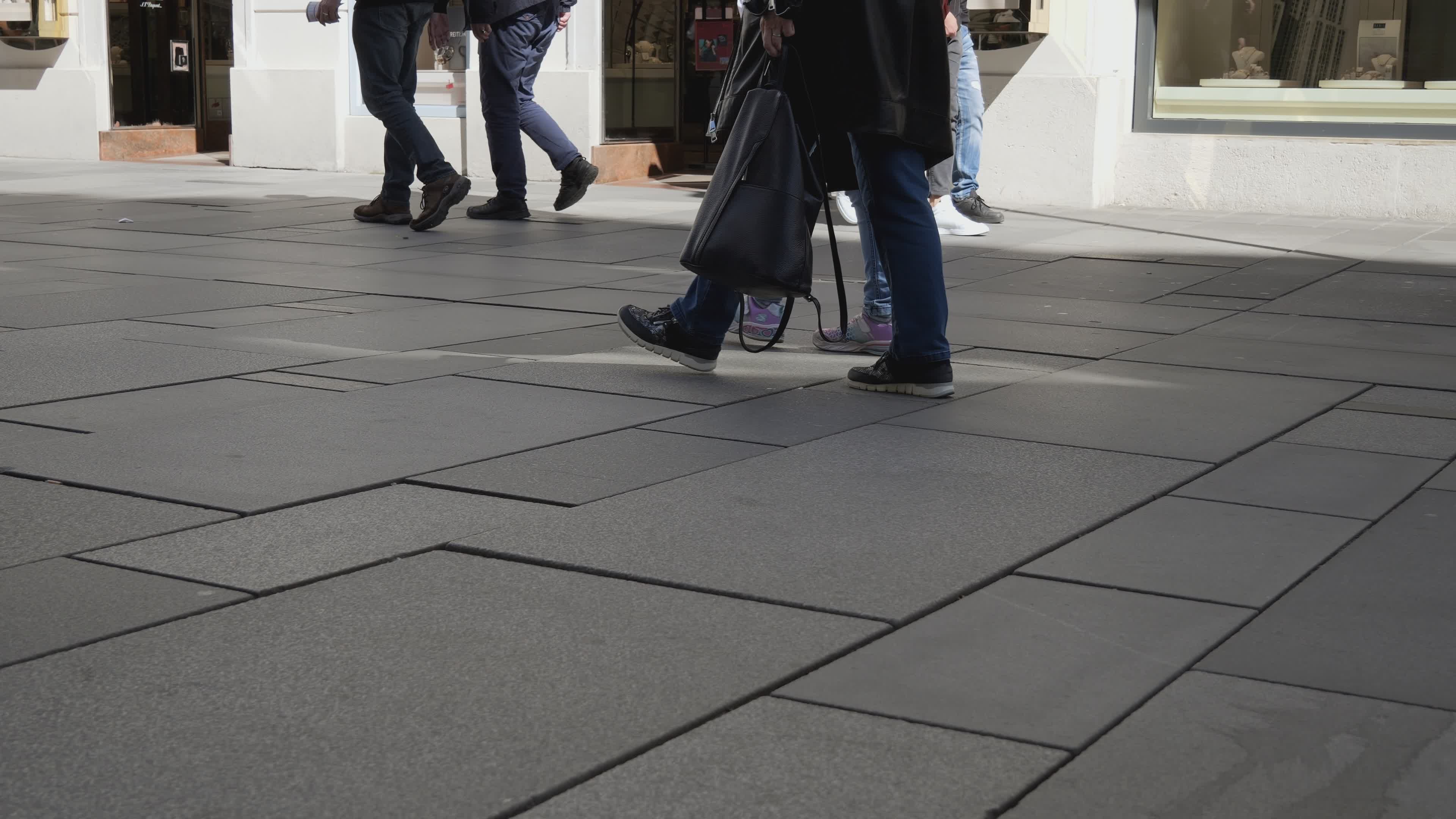 casual pedestrian foot traffic in urban setting 37601314